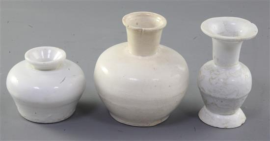 A Chinese Dehua white glazed bottle and two Dehua white glazed vases, Yuan-Ming dynasty, 5.7cm - 9.3cm